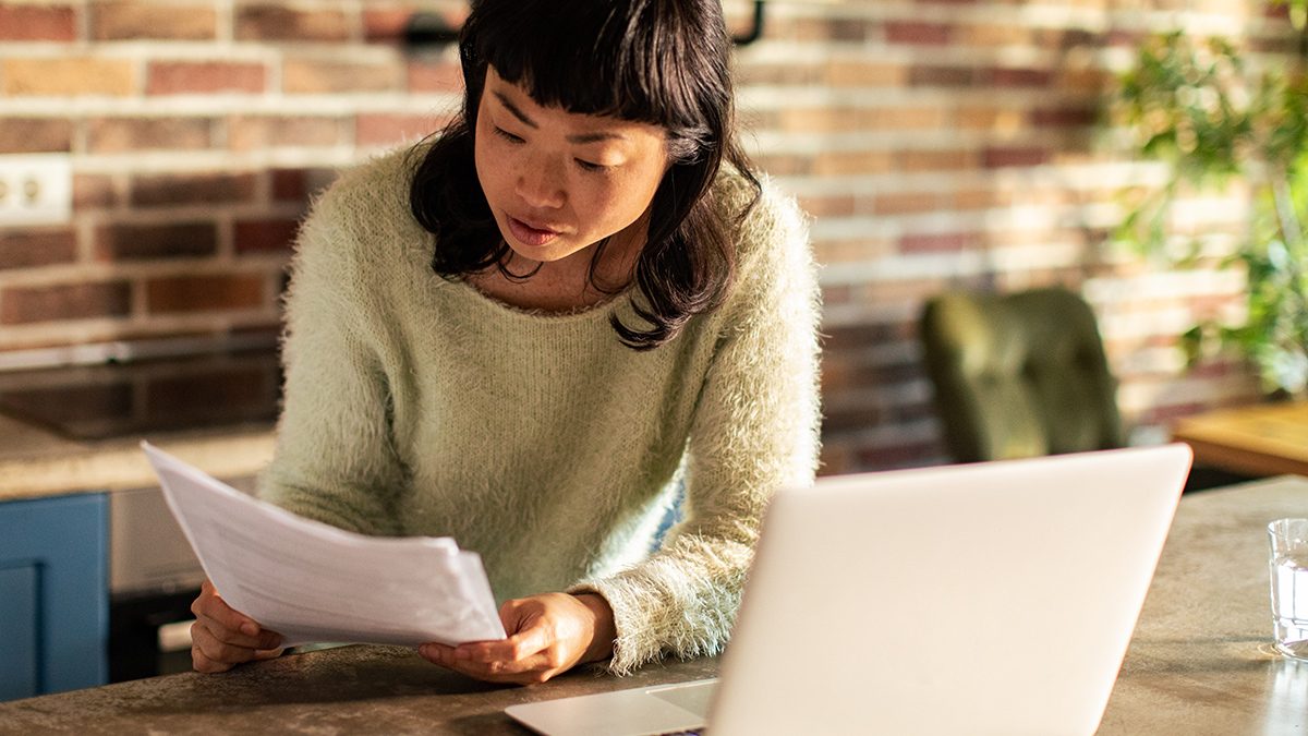 person looking at their energy bill at home