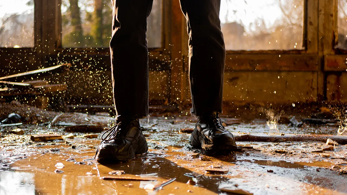 person standing in flooded house