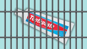 a tube of toothpaste behind metal bars