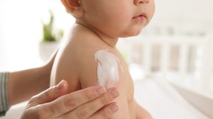 baby having sunscreen applied