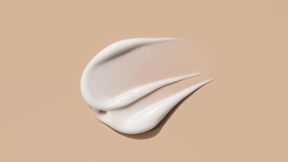 swatch of sunscreen on brown background