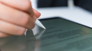 person signing non disclosure agreement on tablet