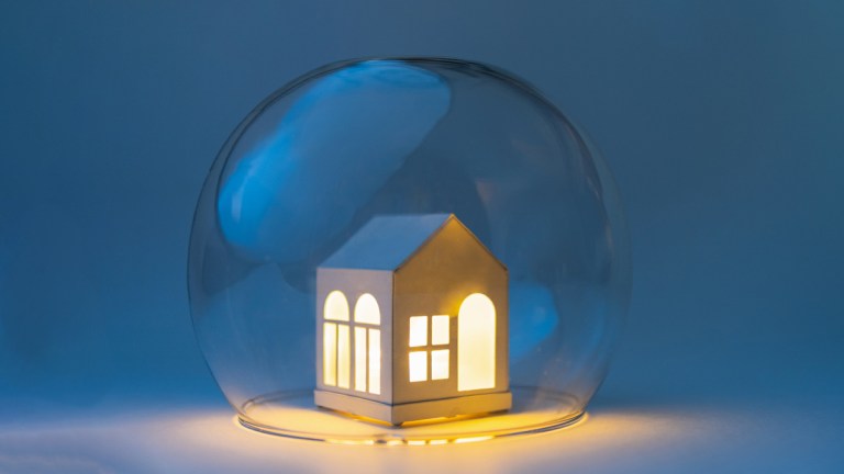 small house with the lights on surrounded by a glass bubble