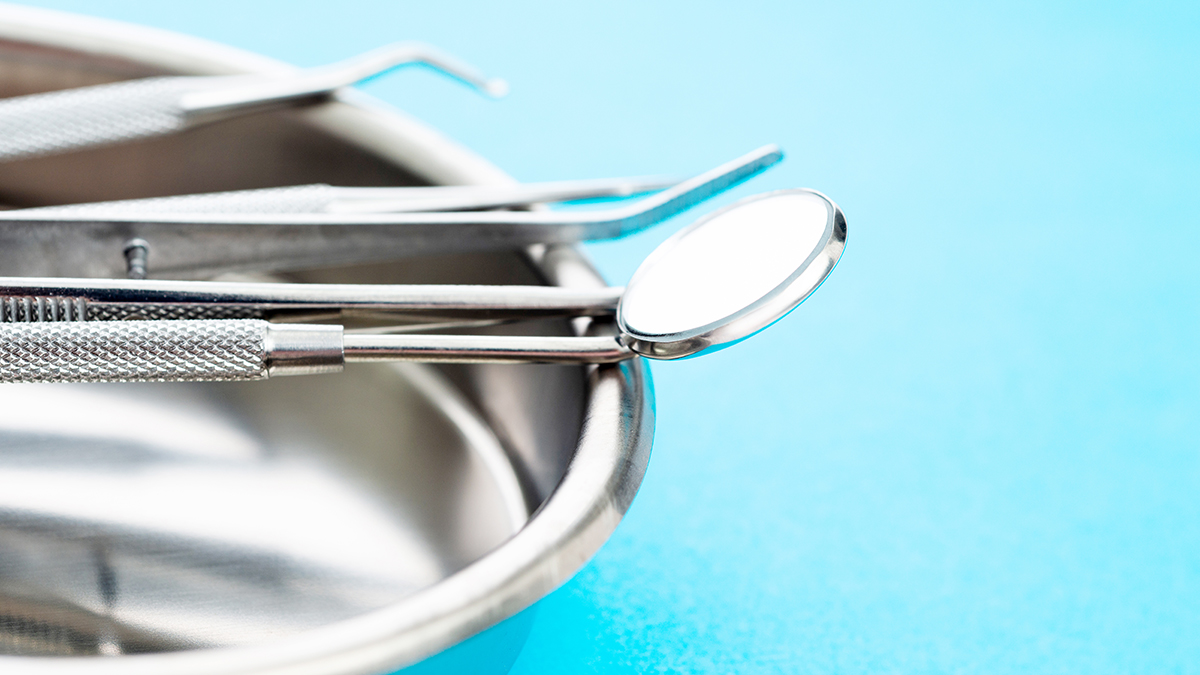 dental tools in tray on blue