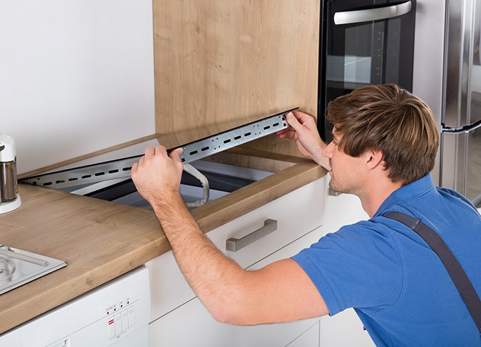electrician installing induction cooktop