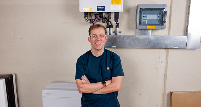 finn_peacock_from_solar_quotes_in_front_of_a_solar_power_system