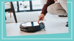 man turning on robot vacuum cleaner