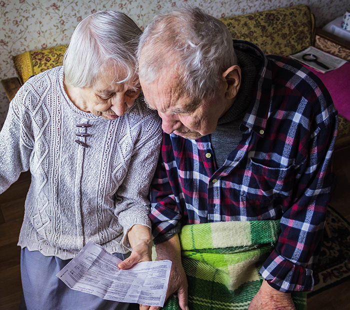 older couple holding timeshare documents