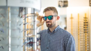 man trying on sunglasses