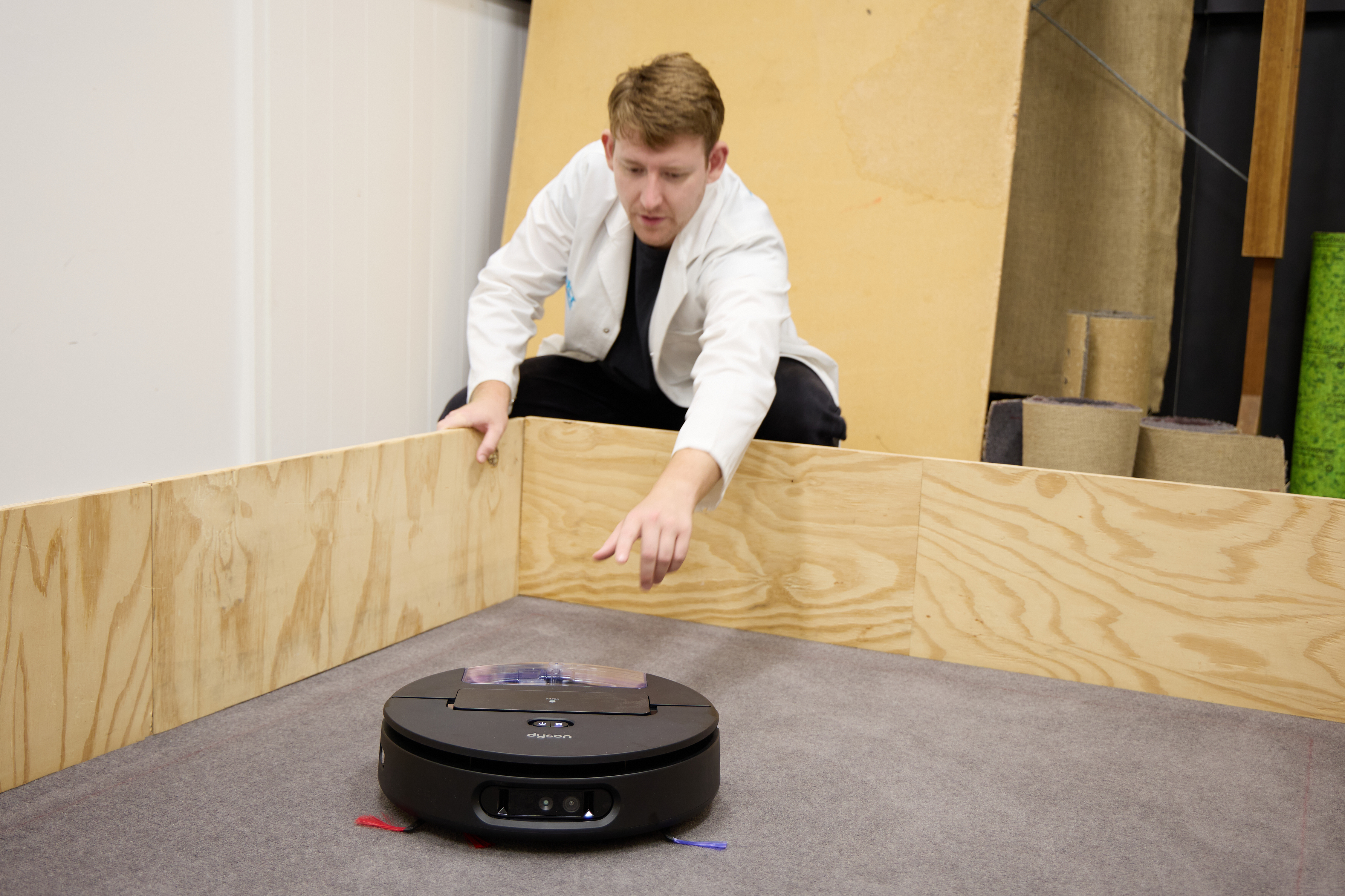Adrian testing the Dyson Spot + Scrub Ai on carpet.
