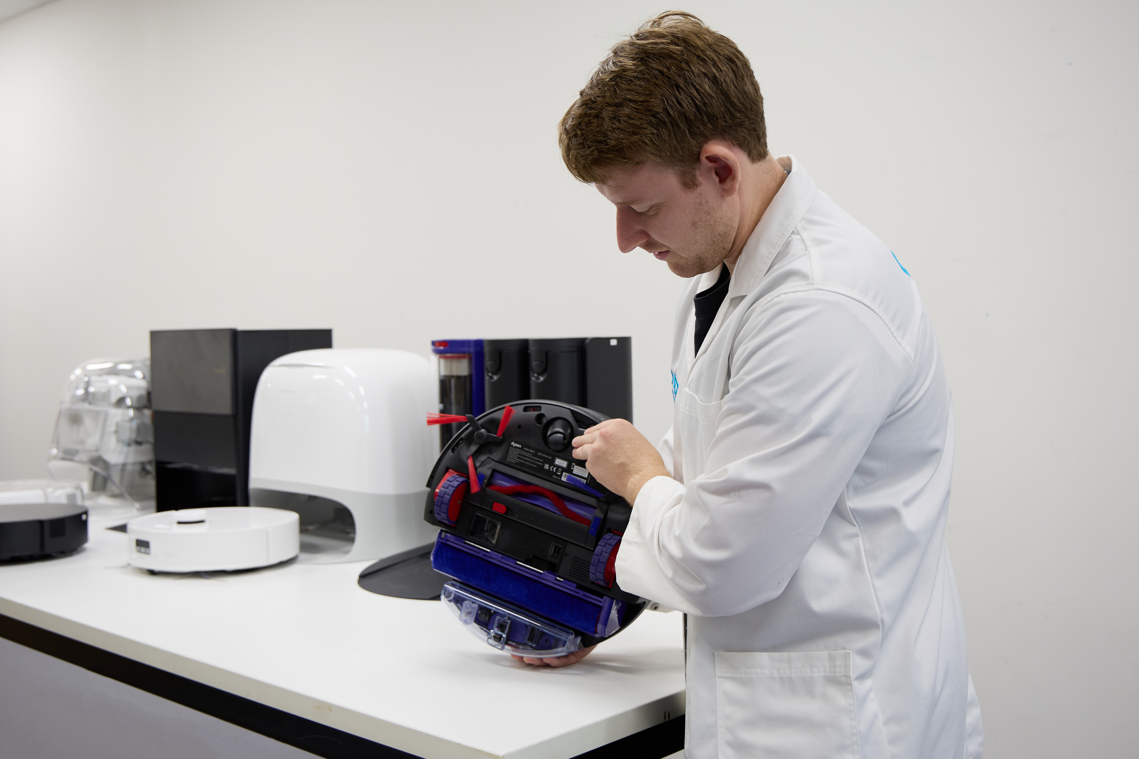 Adrian Lini, CHOICE expert, inspecting the Dyson Spot + Scrub Ai