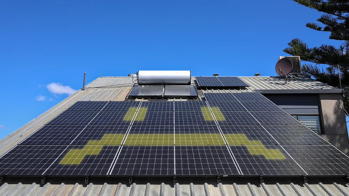 Solar panels on an Australian roof with glowing yellow frown.